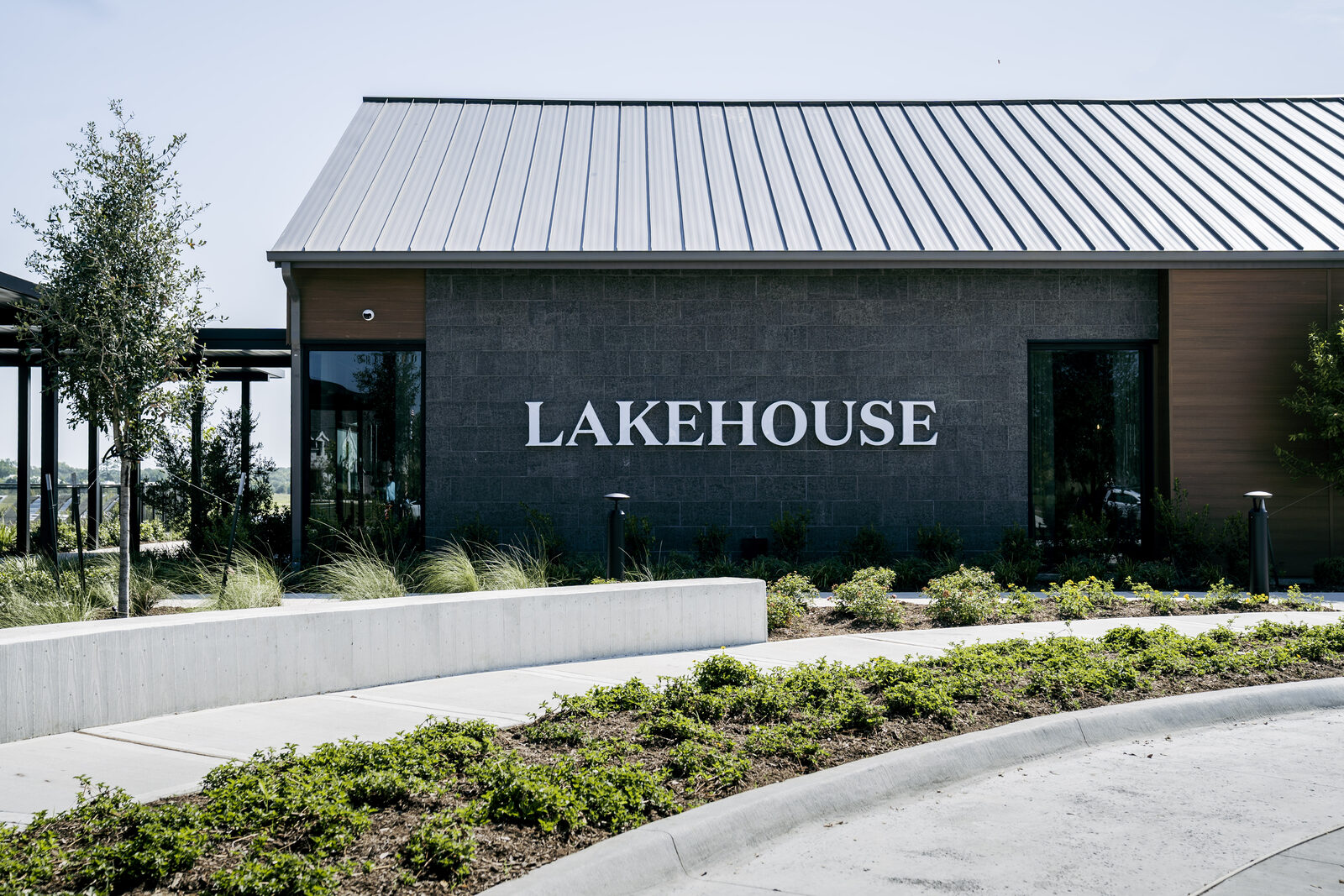 The Lakehouse Amenity Center exterior, with its standing-seam roof and LAKEHOUSE signage.