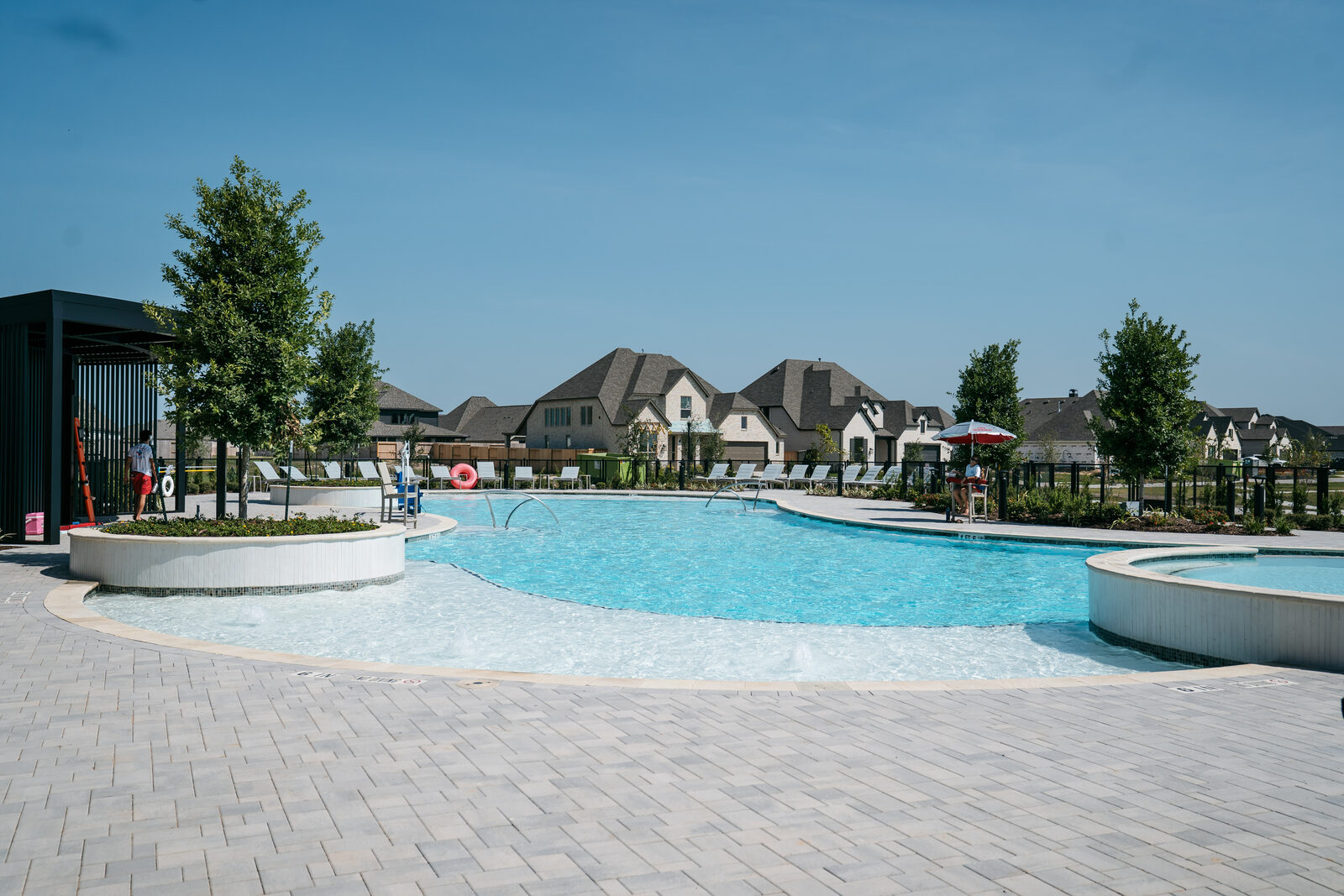 The resort-style pool at the Lakehouse, with loungers, a shade structure and a separate spa.